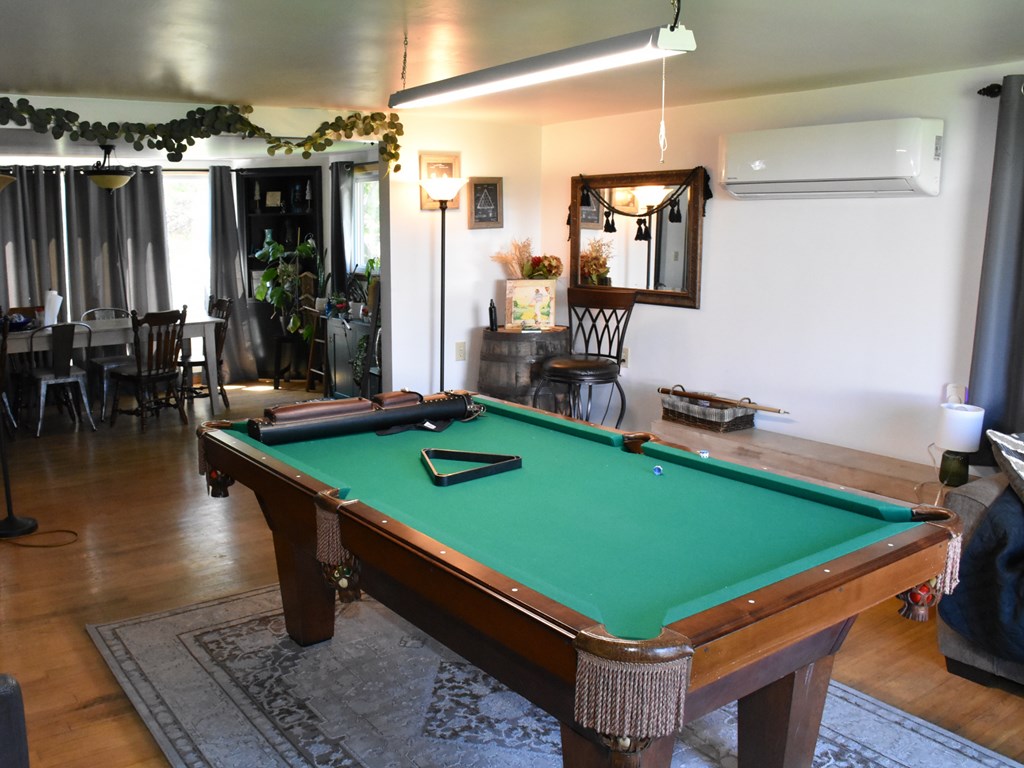 1334 Cochranton Road Carlton, PA 16311 - Photo 17 of 49 a room with pool table two couches and a dining table with wooden floor