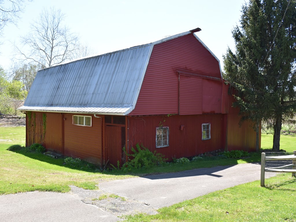 1334 Cochranton Road Carlton, PA 16311 - Photo 44 of 49 a brick house with a small yard and wooden fence
