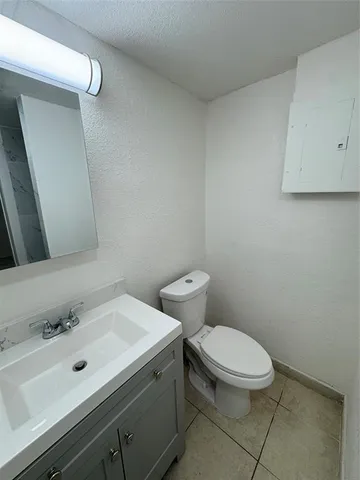 a bathroom with a sink mirror and toilet