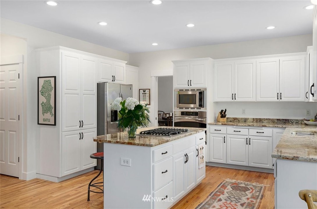 18906 Ross Road Bothell, WA 98011 - Photo 11 of 34 a kitchen with granite countertop a sink stove and cabinets
