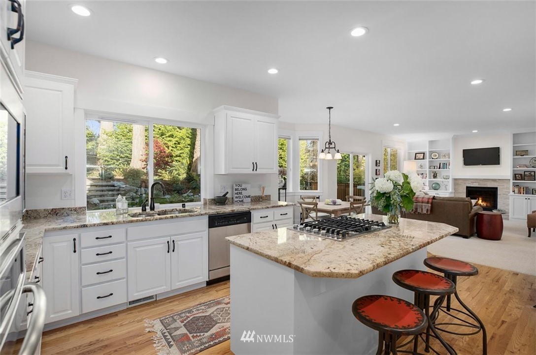 18906 Ross Road Bothell, WA 98011 - Photo 13 of 34 a kitchen with granite countertop a sink and cabinets