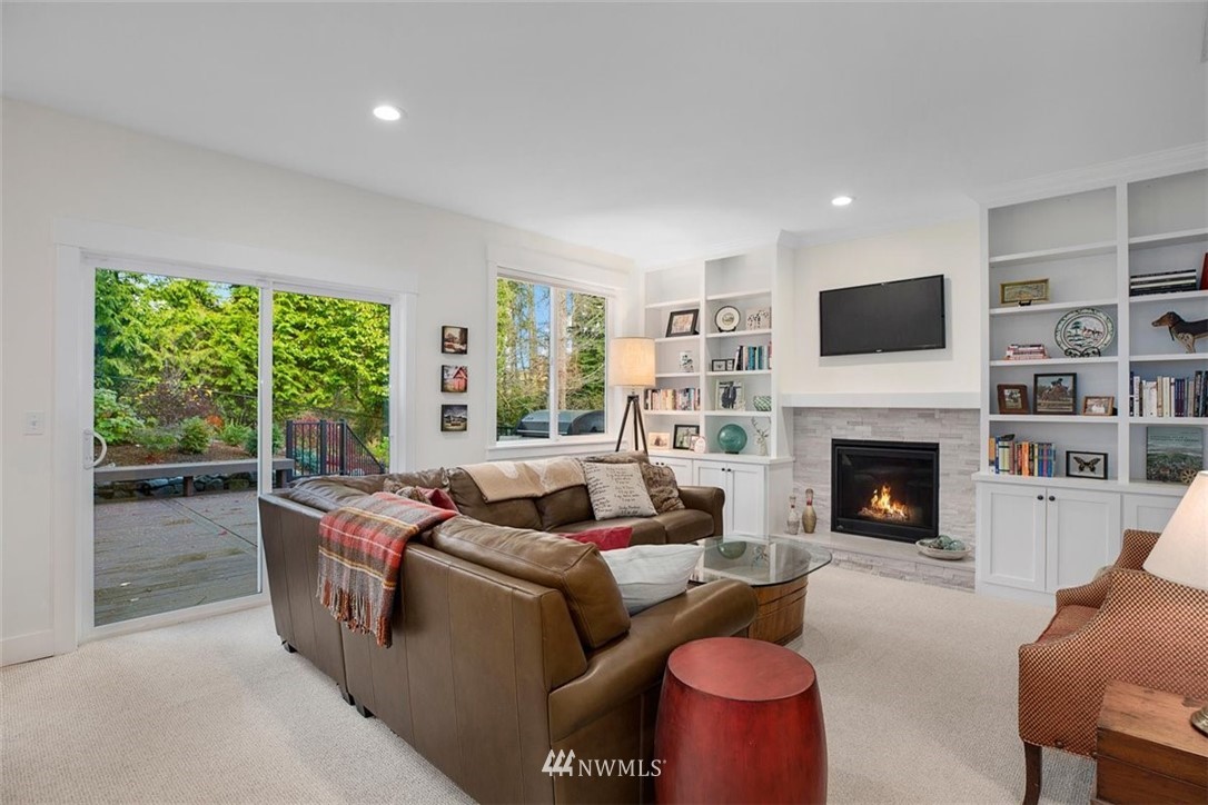 18906 Ross Road Bothell, WA 98011 - Photo 16 of 34 a living room with furniture large window and a fireplace