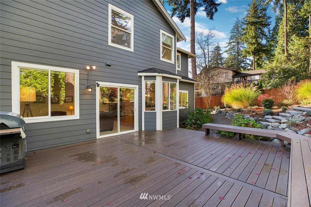 18906 Ross Road Bothell, WA 98011 - Photo 18 of 34 a view of backyard with wooden deck and floor to ceiling window