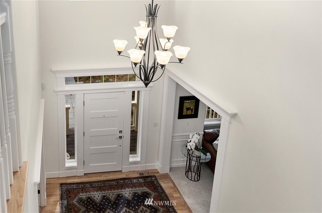 18906 Ross Road Bothell, WA 98011 - Photo 21 of 34 a view of a hallway with entryway and chandelier