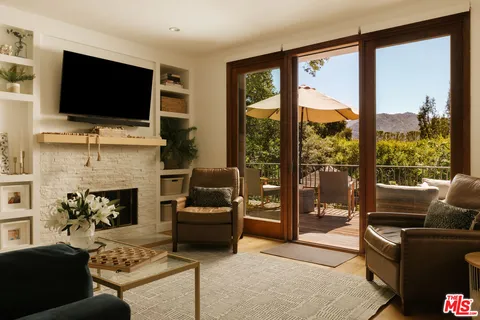a living room with fireplace furniture and a flat screen tv