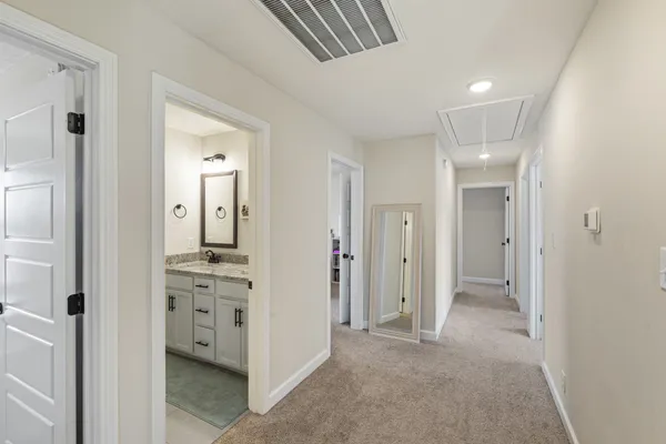 a bedroom with a bed a window and a chandelier