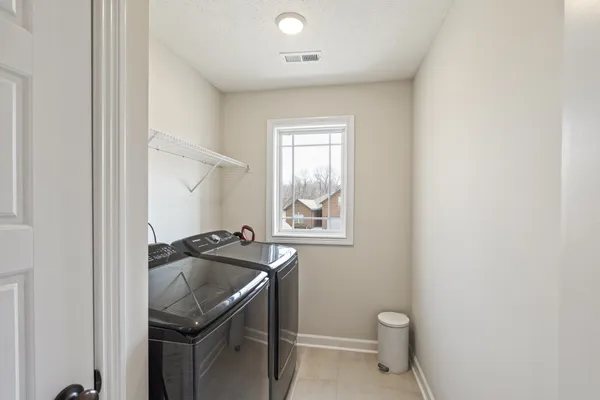 a spacious bedroom with a bed and a window