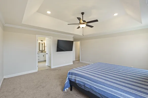 a bathroom with a granite countertop tub sink shower and mirror