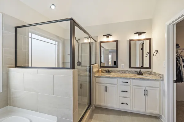 a bathroom with a granite countertop toilet and a sink