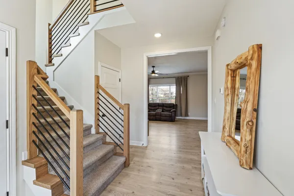 a view of a hallway with closet and stairs