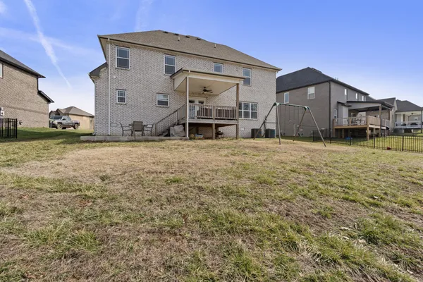 a front view of a house with yard and parking