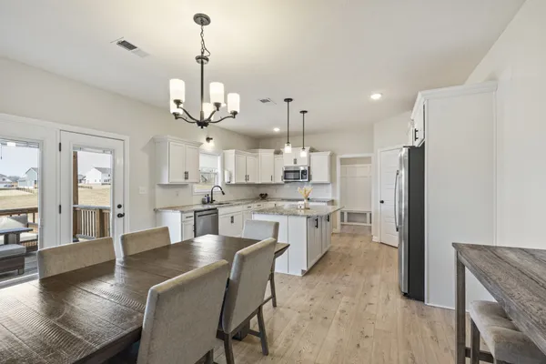 a large kitchen with a table and chairs