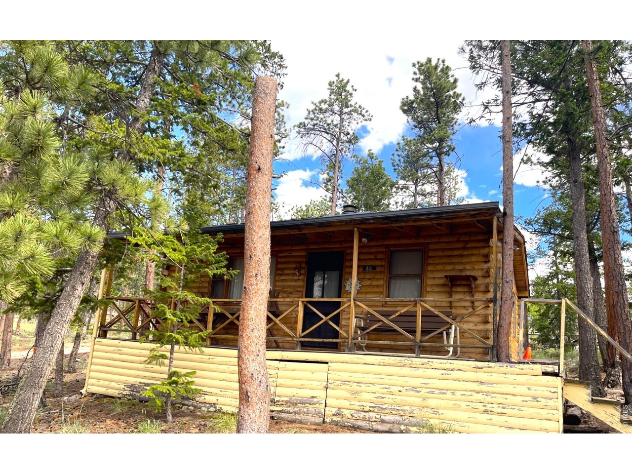 35 Robin Path-north elevation with covered front porch and swing.