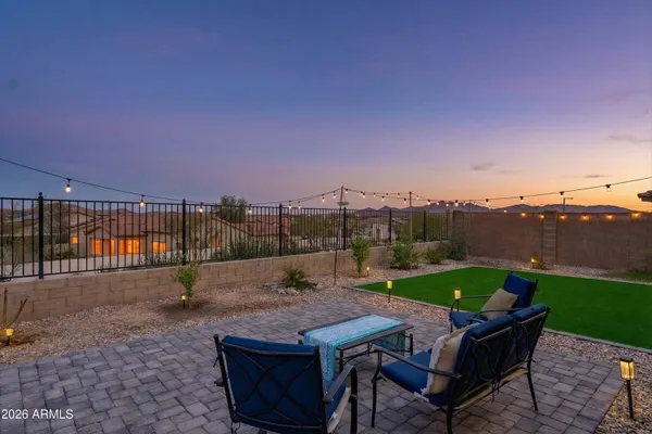 a view of a patio with a table and chairs
