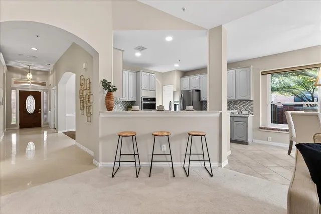 a kitchen with stainless steel appliances kitchen island granite top and refrigerator