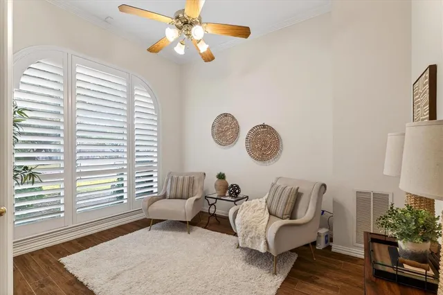a living room with furniture flowerpot and window