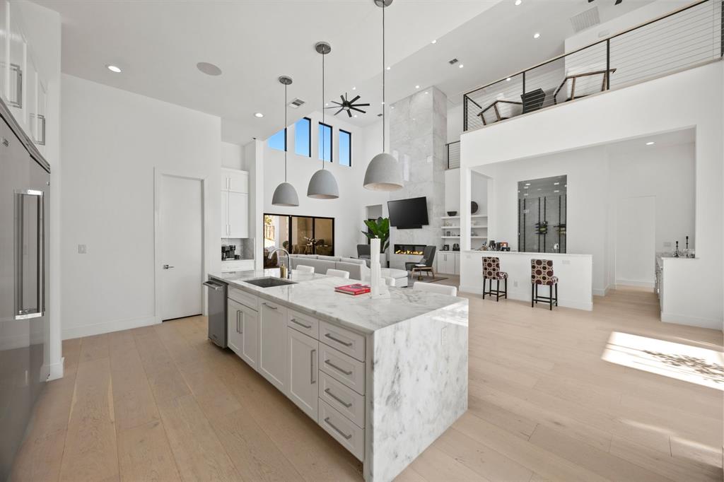 2509 Bella Ridge Keller, TX 76262 - Photo 12 of 34 a kitchen with kitchen island a stove and a view of living room