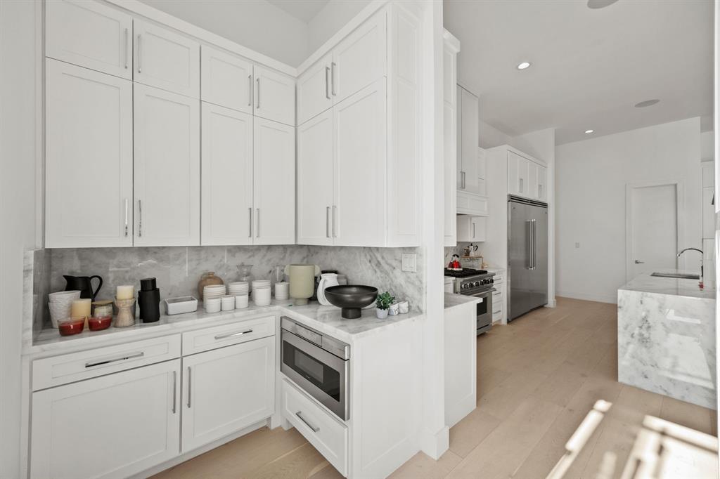 2509 Bella Ridge Keller, TX 76262 - Photo 14 of 34 a kitchen with white cabinets and sink