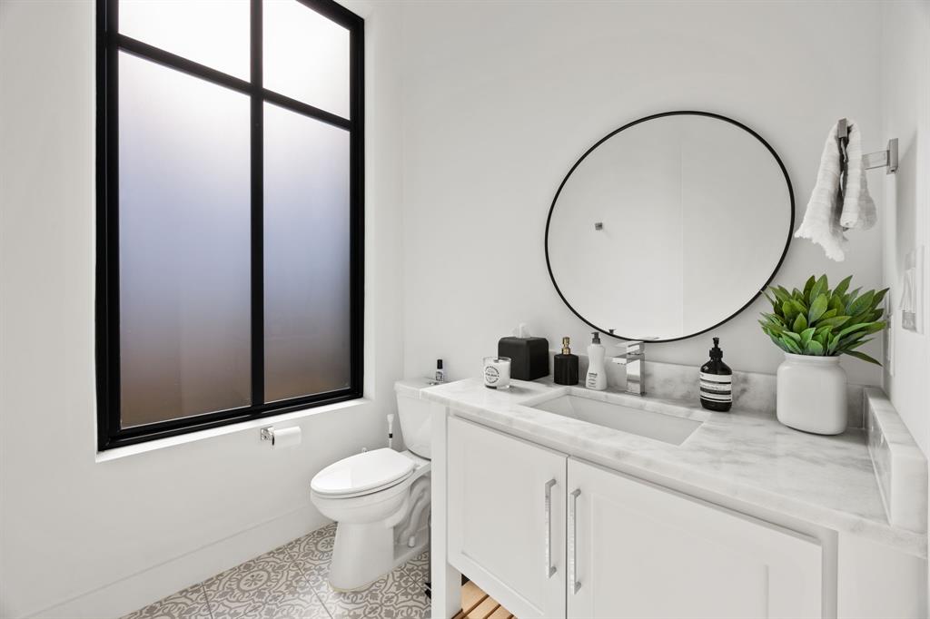 2509 Bella Ridge Keller, TX 76262 - Photo 22 of 34 a bathroom with a toilet a sink and a mirror