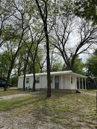 a view of a yard with a house and a tree