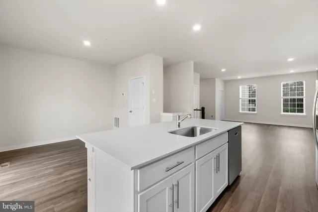 a kitchen with sink and mirror