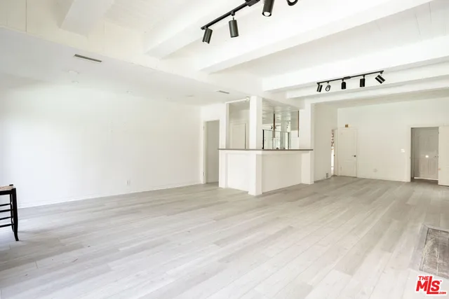 a view of a kitchen with wooden cabinet and refrigerator
