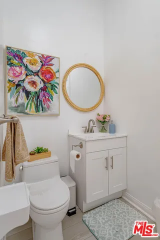 a bathroom with a sink mirror vanity and toilet