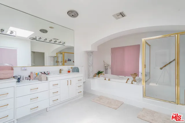 a bathroom with a double vanity sink mirror bathtub and shower