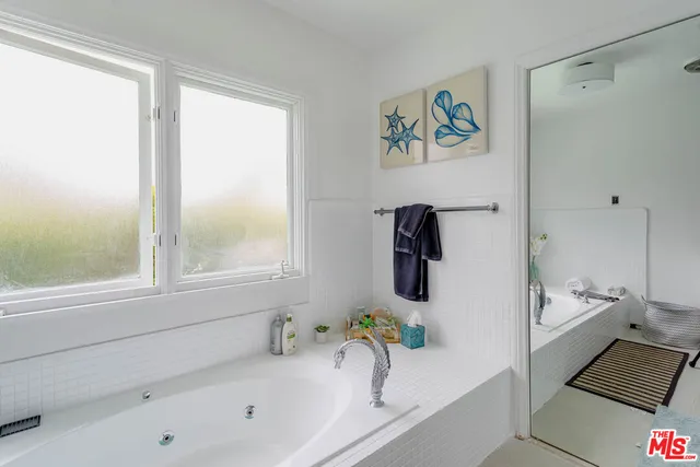 a bathroom with a bathtub and a sink