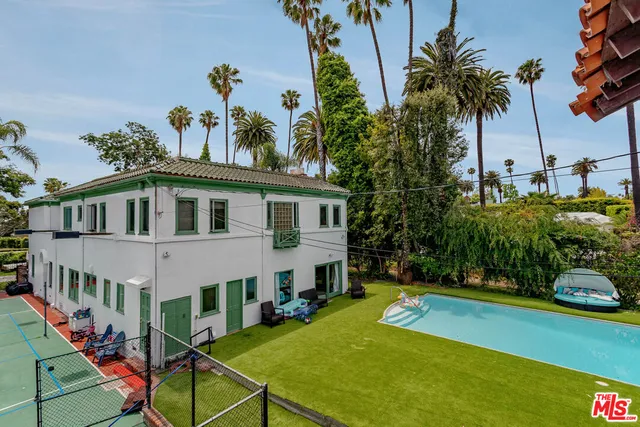 a view of a house with backyard and sitting area