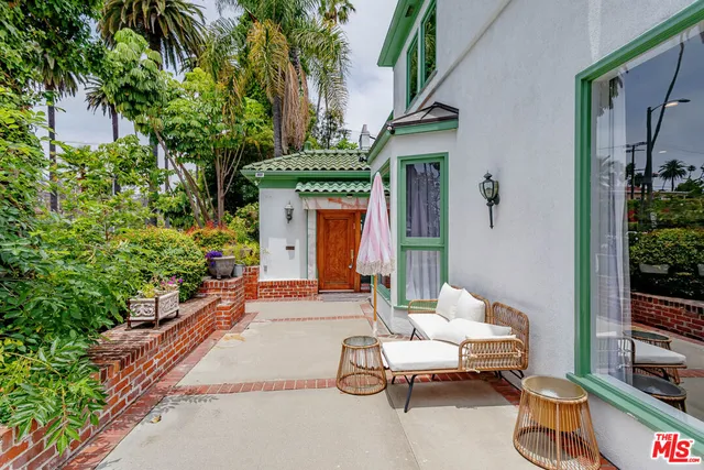 a building outdoor space with patio furniture and potted plants