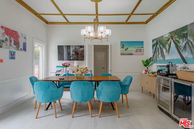 a view of a dining room with furniture and a chandelier
