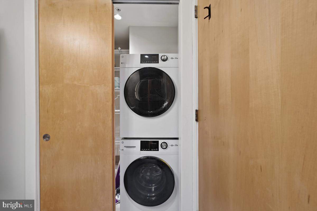 1133 14th Street Northwest, Unit 1103 Washington, DC 20005 - Photo 22 of 39 a utility room with dryer and washer