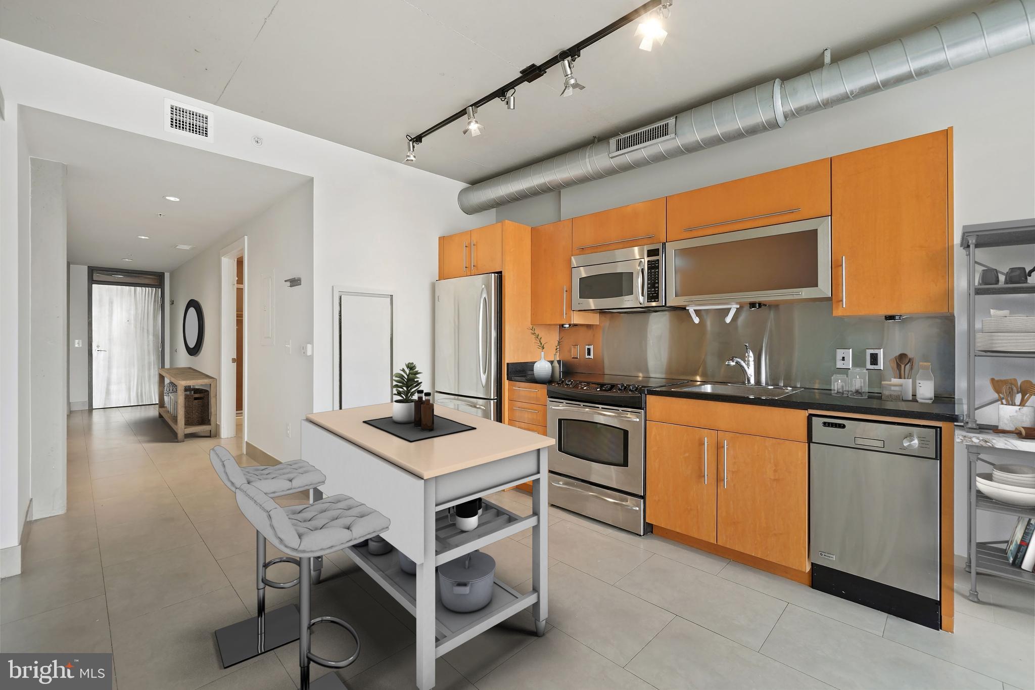 1133 14th Street Northwest, Unit 1103 Washington, DC 20005 - Photo 5 of 39 a kitchen with stainless steel appliances granite countertop a stove a sink dishwasher and a refrigerator