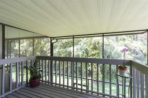 a view of a balcony with wooden floor
