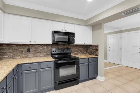 a kitchen with cabinets stainless steel appliances and a counter space
