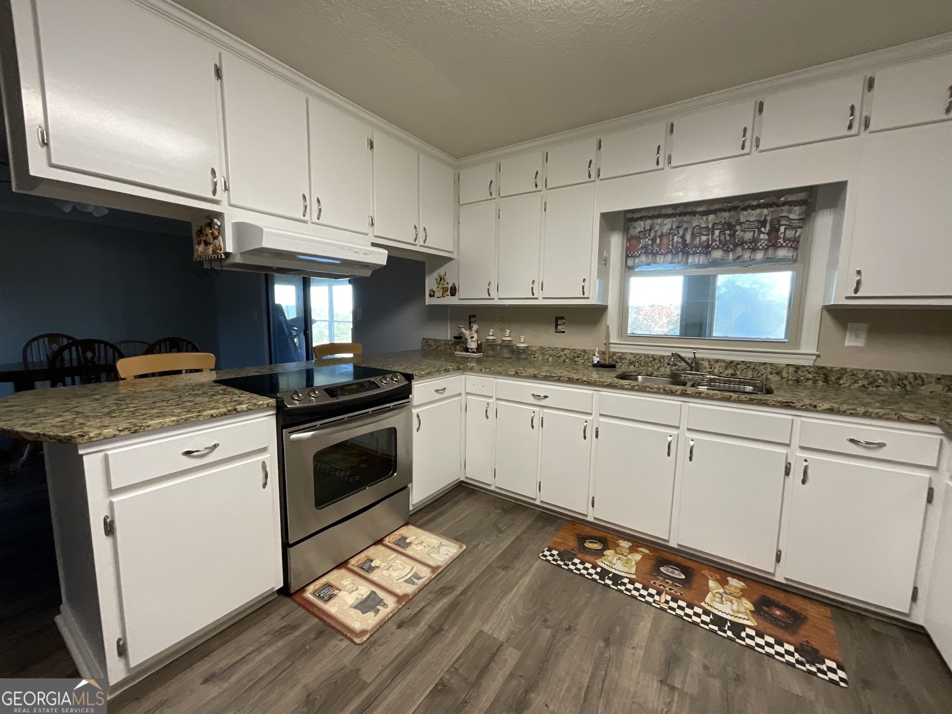 501 Raleigh Road Woodbury, GA 30293 - Photo 19 of 94 a kitchen with granite countertop white cabinets and white appliances