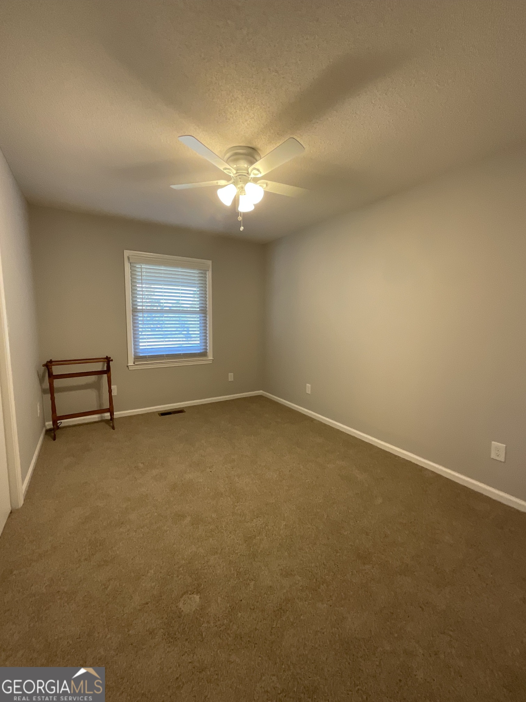 501 Raleigh Road Woodbury, GA 30293 - Photo 29 of 94 an empty room with a empty space and windows