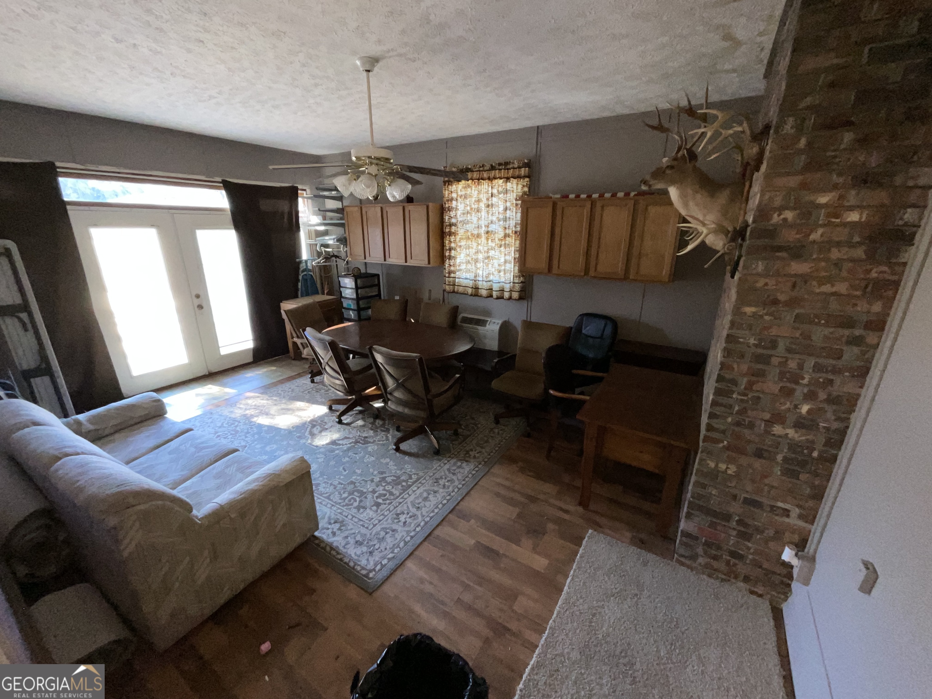 501 Raleigh Road Woodbury, GA 30293 - Photo 37 of 94 a living room with furniture and a chandelier