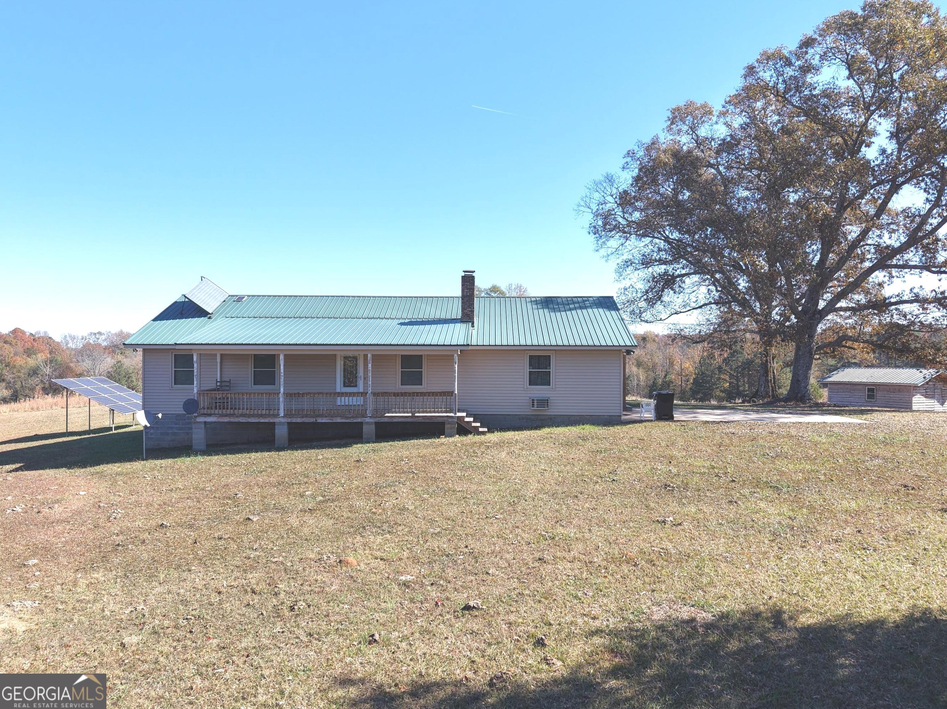 501 Raleigh Road Woodbury, GA 30293 - Photo 10 of 94 a view of a yard in front of a house with a large tree