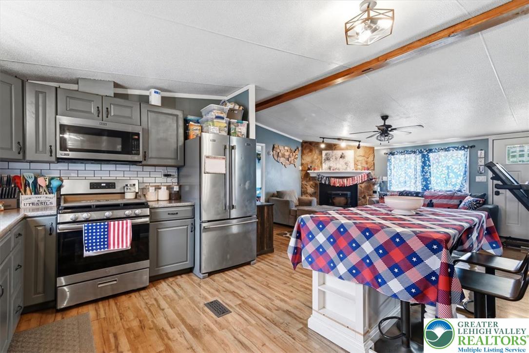 634 Main Road Lehighton, PA 18235 - Photo 10 of 39 A well-equipped culinary space boasts stainless steel appliances and an inviting open-concept layout.