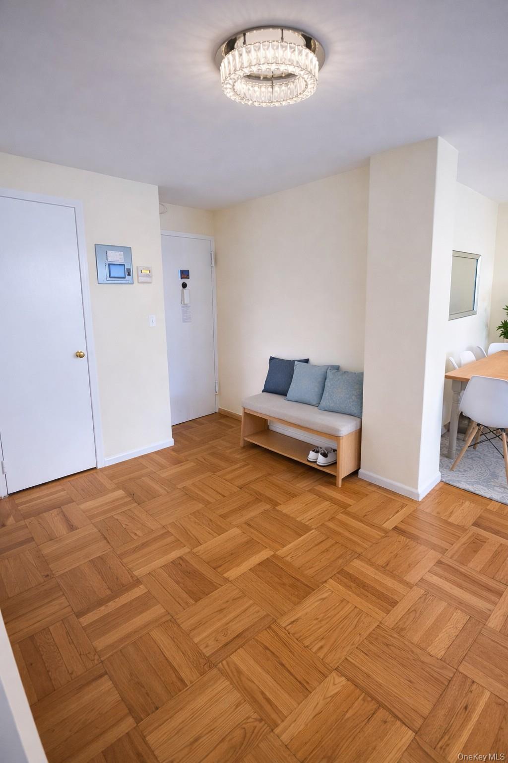 21-20 33rd Road, Unit 10B Queens, NY 11106 - Photo 11 of 17 a bedroom with a bed and a chandelier