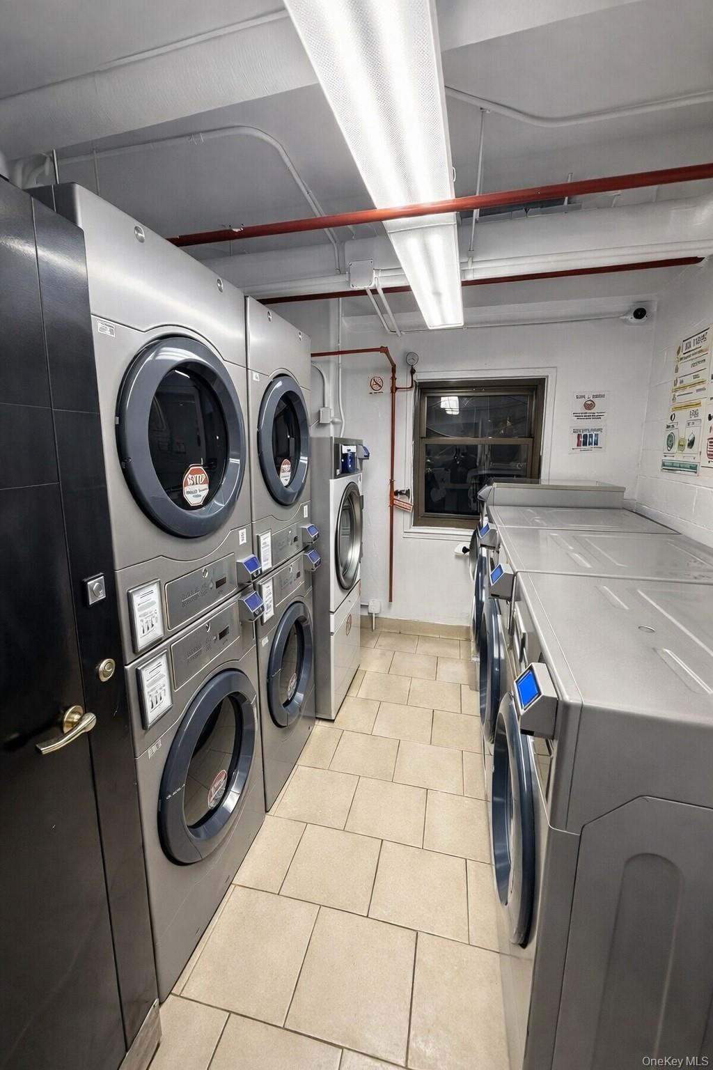 21-20 33rd Road, Unit 10B Queens, NY 11106 - Photo 16 of 17 a utility room with dryer and washer
