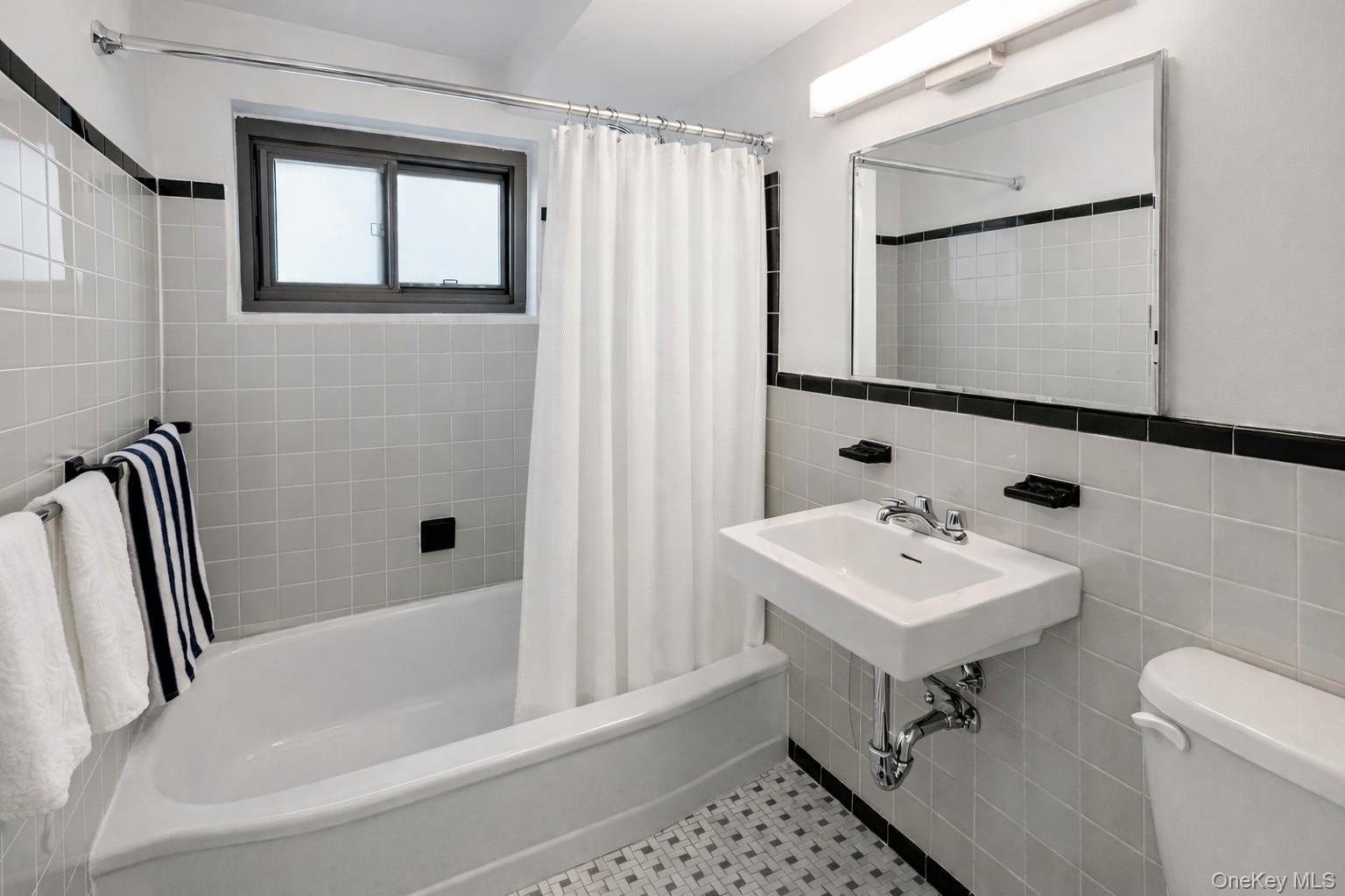 21-20 33rd Road, Unit 10B Queens, NY 11106 - Photo 7 of 17 a bathroom with a sink toilet and shower