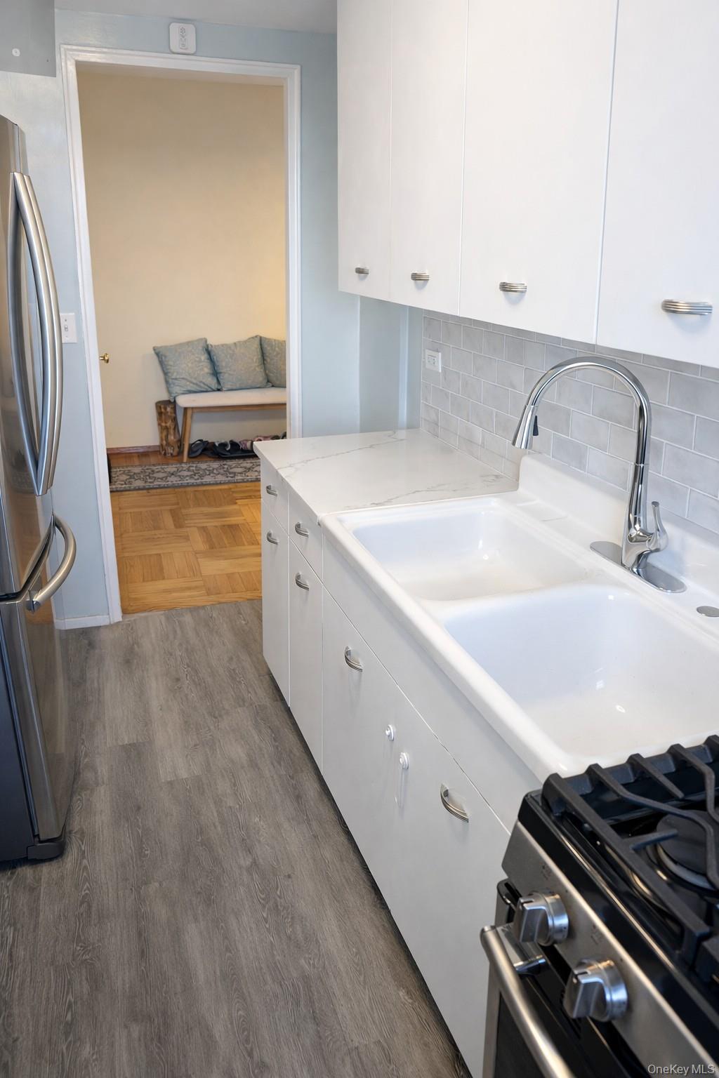21-20 33rd Road, Unit 10B Queens, NY 11106 - Photo 10 of 17 a kitchen with stainless steel appliances granite countertop a sink and a stove