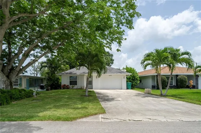 a front view of house with a garden
