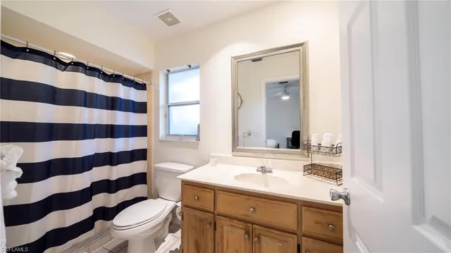 a bathroom with a sink a toilet a shower and a mirror