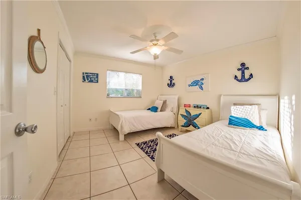 a bedroom with two beds and a table