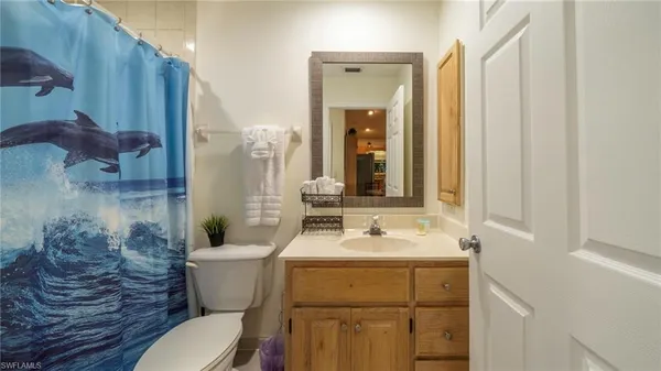 a bathroom with a sink mirror toilet and shower