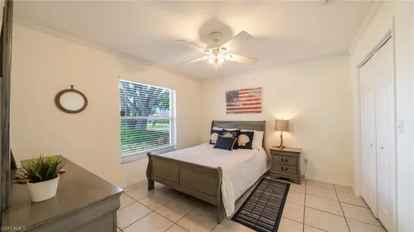 a bedroom with a bed and window